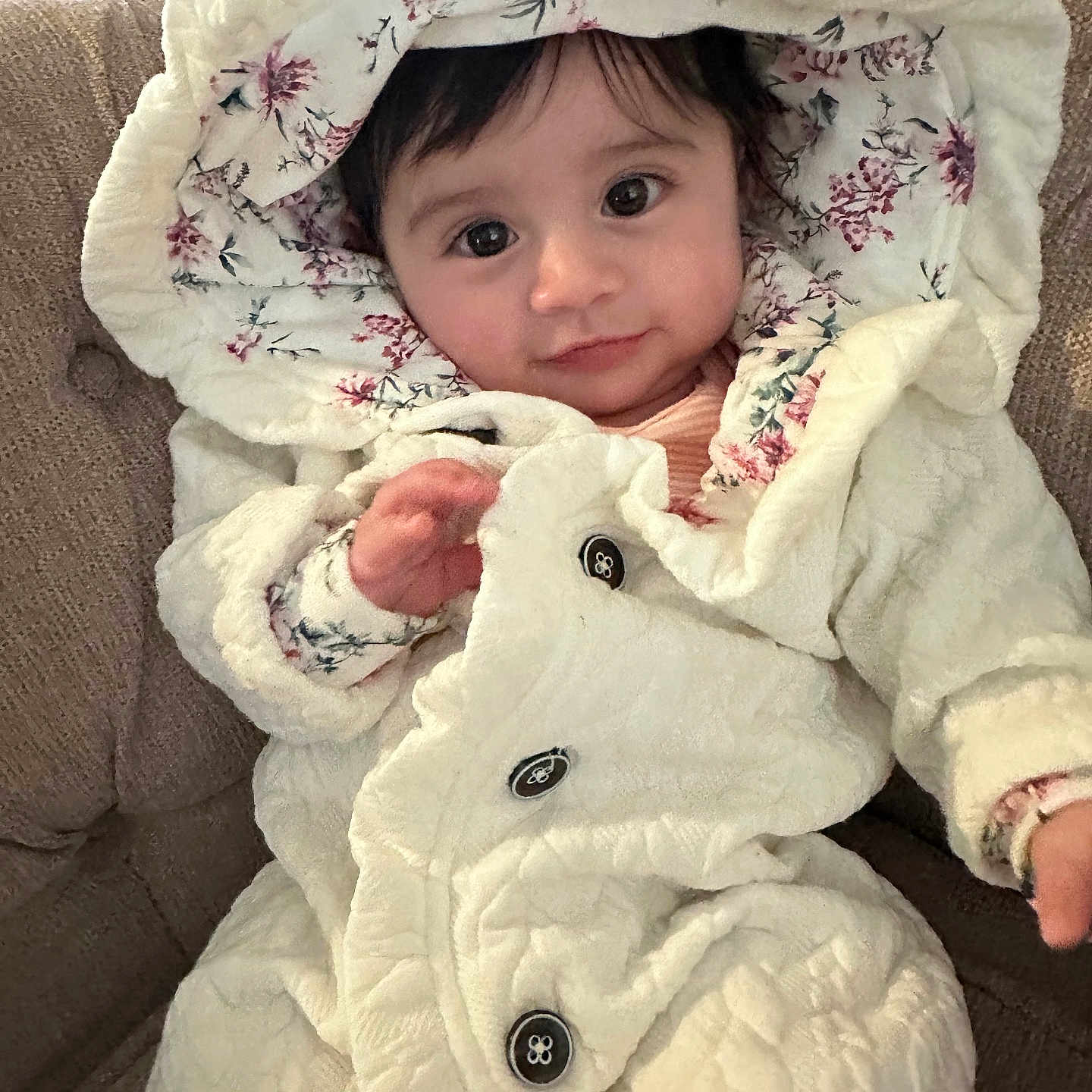 Athena is registered to the contest to win money with this photo: baby, blanket, bonnet, clothing, coat, face, hat, head, hood, jacket, knitwear, nature, outdoors, person, photography, portrait, snow, snowman, sweater, winter
