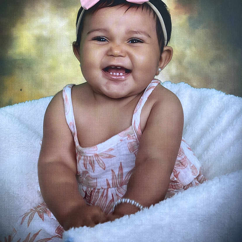 Kamilah is registered to the contest to win money with this photo: accessories, baby, babylaughing, baseballcap, bodypart, cap, clothing, dress, face, finger, hand, happy, hat, head, laughing, mouth, person, photography, portrait, smile