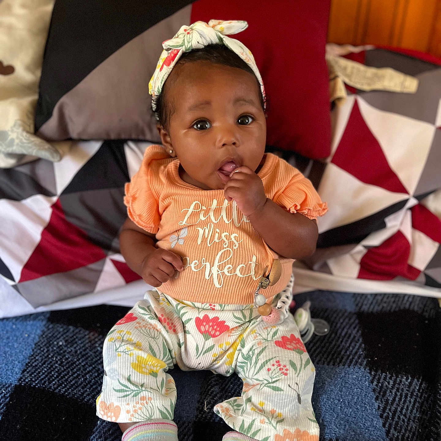 Kamaria is registered to the contest to win money with this photo: baby, bed, bedroom, clothing, couch, cushion, face, furniture, hat, head, homedecor, hosiery, indoors, pants, person, photography, portrait, room, sitting, sock