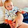 adult, baby, caring, close_up, comfort, curious_expression, family, feet, hand, holding, indoor, infant, pajamas, person, red_hair, relax, sea_creatures, skin, soft_light, white_shirt