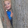 Seth joined the competition — help win amazing prizes! child, toddler, smiling, face, blue_shirt, tree, tree_trunk, wood, nature, outdoor, peek, happy, person, young_child, skin, eyes, hand, playful, daylight, casual