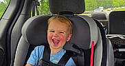 Seth joined the competition — help win amazing prizes! toddler, child, car_seat, car_interior, blue_shirt, smiling, laughing, drink, red_straw, seatbelt, window, trees, daylight, vehicle, happy, person, safety, transportation, cute, casual