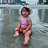 toddler, child, beach, sand, water, swimsuit, hat, sunhat, urban, buildings, umbrella, reflection, summer, outdoor, vacation, sitting, cute, baby, sky, clouds
