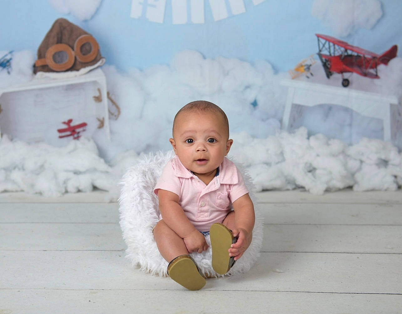 Rj joined the competition — help win amazing prizes! aircraft, baby, baby_toddler_clothing, child, event, flooring, freezing, fun, happy, leisure, mammal, person, pink, red, sitting, smile, snow, toddler, white, winter
