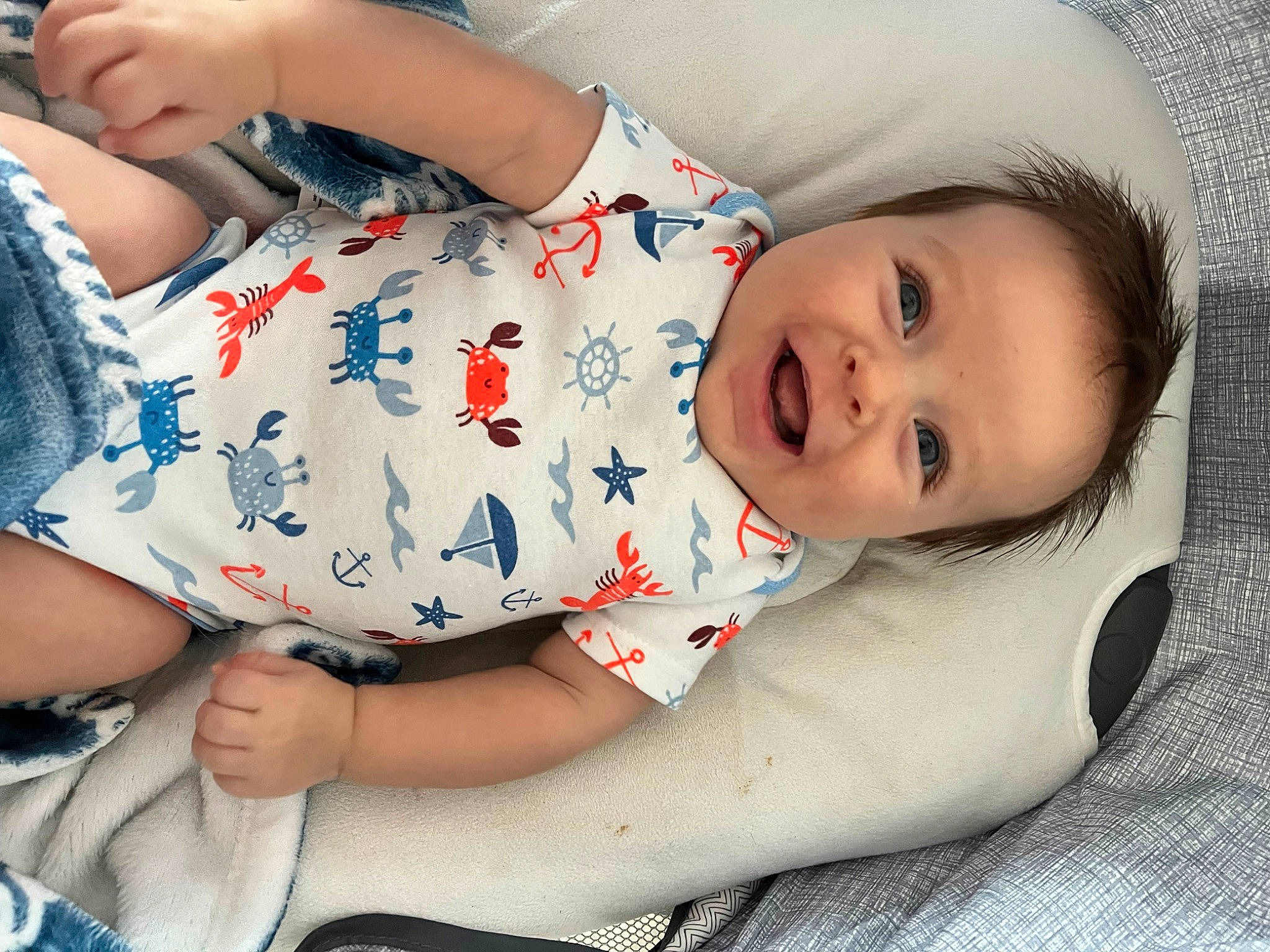 Cayson is registered to the contest to win money with this photo: baby, baby_toddler_clothing, cheek, comfort, dress, elbow, finger, happy, human_leg, lip, mouth, neck, nose, pattern, person, sitting, skin, sleeve, smile, thigh