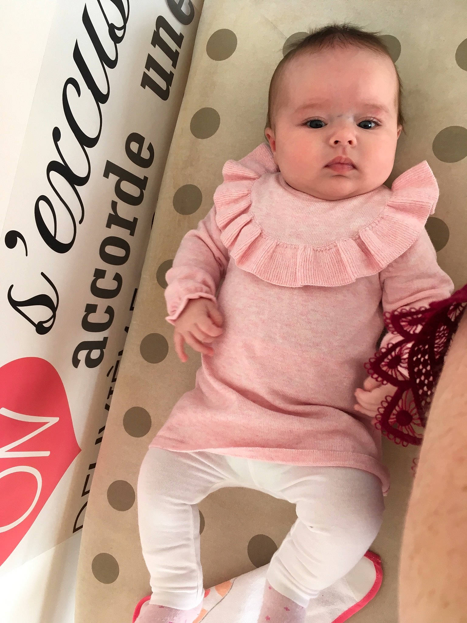 April participe au concours pour gagner de l'argent avec cette photo : baby_products, child, day, girl, infant, material, outerwear, pattern, person, pink, product, sitting, skin, sleeve, smile, textile, toddler