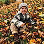 child, toddler, beanie, hat, autumn, fall_leaves, leaves, grass, boots, jacket, smile, outdoors, park, bench, cozy, portrait, candid, seasonal, playful, snack