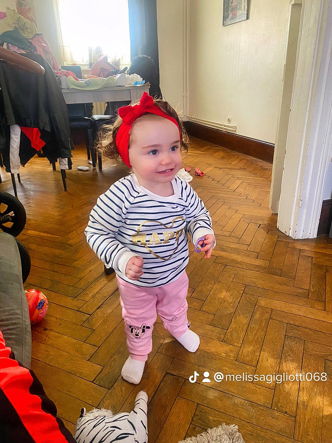 Inès participe au concours pour gagner de l'argent avec cette photo : baby, baby_toddler_clothing, beauty, child, curtain, door, event, facial_expression, floor, flooring, fun, happy, hardwood, headwear, joy, leg, mammal, person, smile, sock