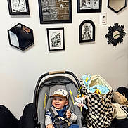 Amin joined the competition — help win amazing prizes! baby, baby_clothes, bag, black_frame, car_seat, checkerboard_pattern, child, decor, furniture, happy, hat, indoor, infant, mirror, person, plush_toy, room, seat_belt, smiling, wall_art