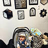 baby, baby_clothes, bag, black_frame, car_seat, checkerboard_pattern, child, decor, furniture, happy, hat, indoor, infant, mirror, person, plush_toy, room, seat_belt, smiling, wall_art