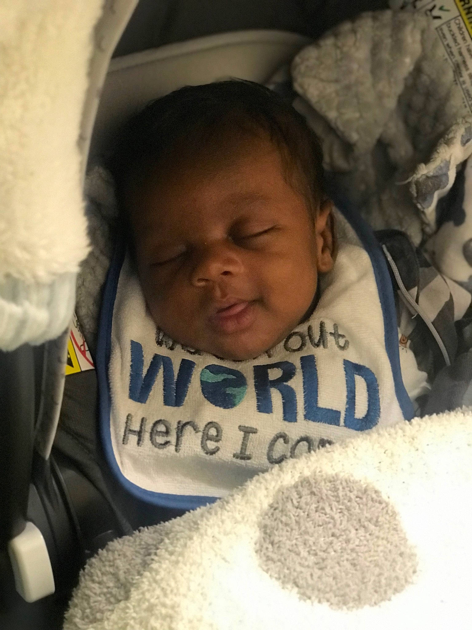 Karson is registered to the contest to win money with this photo: baby, cheek, child, chin, comfort, eyebrow, eyelash, forehead, hairstyle, happy, headgear, human, linens, mammal, mouth, nose, organ, person, skin, toddler