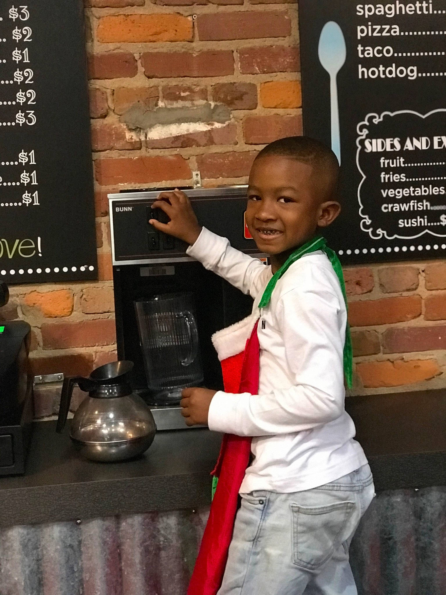 Robert Jr is registered to the contest to win money with this photo: blackboard, brick, brickwork, chalk, child, font, hairstyle, handwriting, happy, home_appliance, joy, logo, person, room, smile, standing, t_shirt, tableware, television, toddler