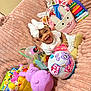 Sayuri is registered to the contest to win money with this photo: baby, child, smiling, white_bow, headband, pink_blanket, toys, purple_bunny, pets_alive, fur_nates, stuffed_animals, basket, white_outfit, gold_bracelets, happy, indoor, playtime, cute, colorful, infant