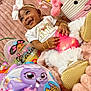 baby, child, smiling, easter, toy, plush, blanket, pink, gold, headband, bracelet, tutu, shoe, indoor, celebration, holiday, cute, person, portrait, happy