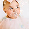 Layken is registered to the contest to win money with this photo: baby, child, face, headband, bow, pink, dress, cream, cake, cheeks, portrait, closeup, cute, infant, bokeh, lights, soft_focus, smile, happy, young