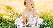 Layken is registered to the contest to win money with this photo: baby, bubbles, foam, grass, outdoor, sunlight, water, basin, splash, child, playful, happy, skin, nature, summer, sitting, soap, fun, innocence, cute