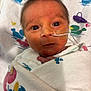 Bobby Ray Coca Iii is registered to the contest to win money with this photo: newborn, baby, infant, wrapped, blanket, nasal_tube, hospital, face, eyes, hair, medical, cute, small, child, patient, lying_down, closeup, healthcare, swaddled, portrait