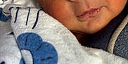 Bobby Ray Coca Iii is registered to the contest to win money with this photo: baby, sleeping, face, blanket, hat, closeup, skin, child, cozy, infant, peaceful, warm, soft, newborn, wrapped, portrait, cute, resting, indoors, comfort