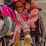 baby, baseball, bonnet, chair, clothing, couch, crib, face, footwear, furniture, glove, hat, head, infantbed, person, shoe, shorts, sneaker, toy, wheelchair