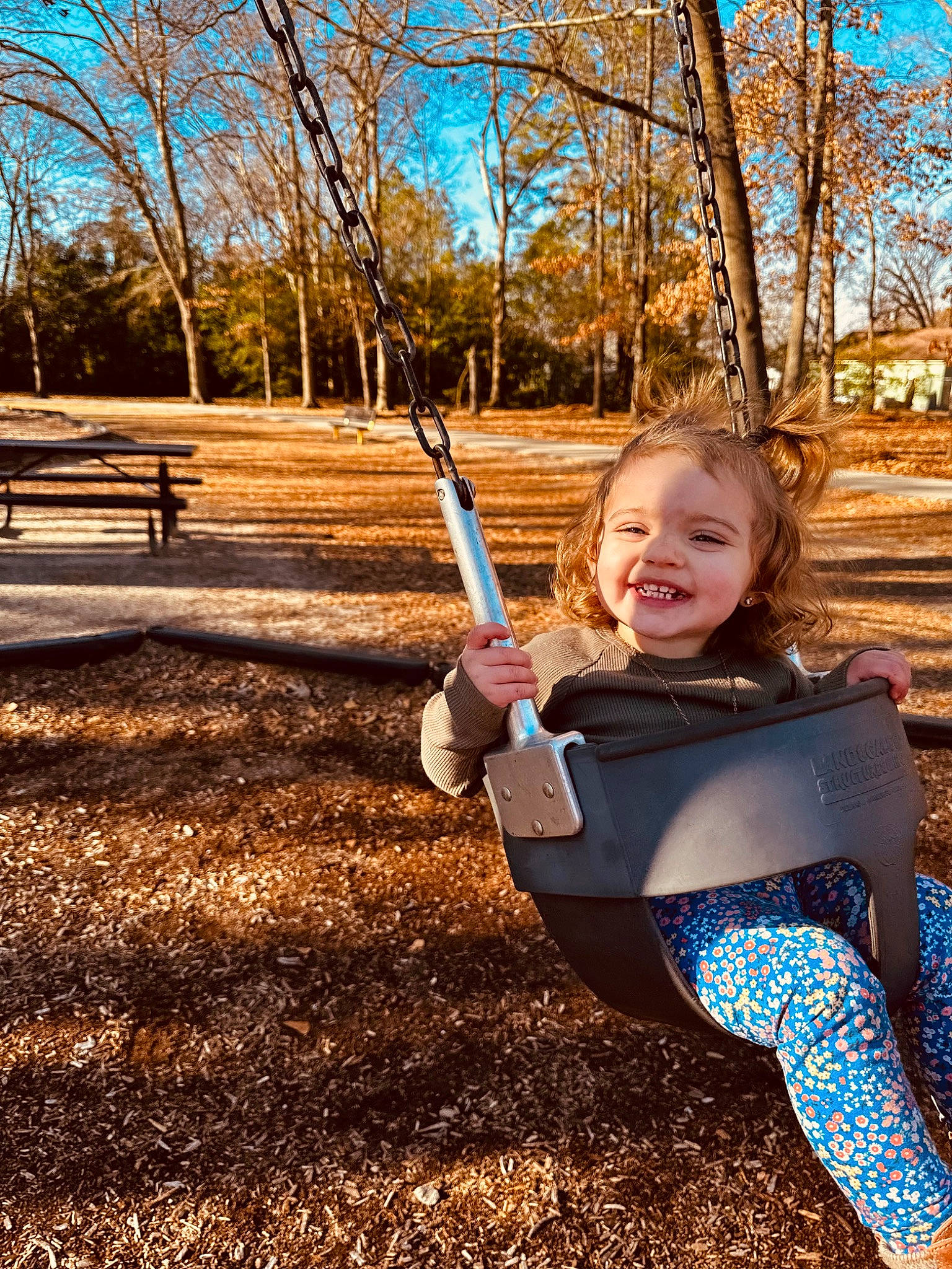 Ashlynn is registered to the contest to win money with this photo: branch, child, city, electric_blue, flash_photography, forest, grass, happy, joy, leisure, outdoor_play_equipment, people_in_nature, person, plant, recreation, sky, soil, spring, toddler, tree