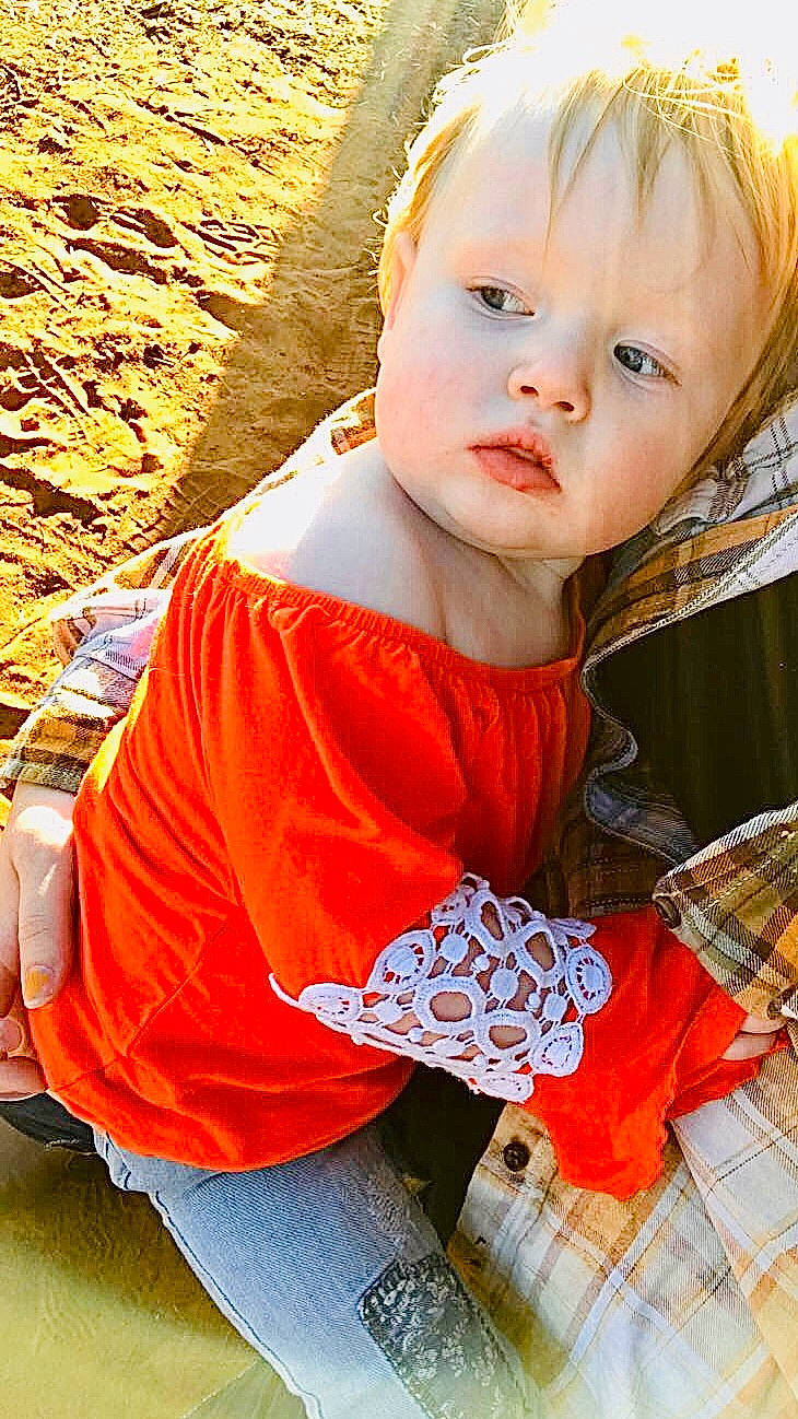 Bristol joined the competition — help win amazing prizes! baby, baby_toddler_clothing, blond, child, cool, face, grass, hairstyle, happy, nose, orange, organ, pattern, people_in_nature, person, photograph, sitting, skin, sleeve, t_shirt