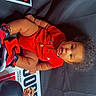 Jacarri joined the competition — help win amazing prizes! baby, balloons, basketball, black_background, celebration, child, curly_hair, cute, event, gold_chain, indoor, infant, michael_jordan, portrait, poster, red_clothing, sitting, sneakers, sportswear, toy