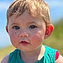 child, toddler, face, blue_sky, outdoor, green_clothing, skin, hair, eyes, cheeks, person, summer, sunlight, portrait, cute, innocence, expression, head, baby, casual_wear