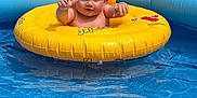 Lyla participe au concours pour gagner de l'argent avec cette photo : baby, child, inflatable_ring, pool, water, blue, yellow, outdoor, summer, cute, happy, floating, splash, toddler, swimming, play, fun, person, skin, sunlight