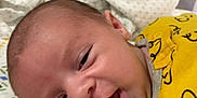 Elijah joined the competition — help win amazing prizes! baby, infant, yellow_clothing, blanket, patterned_blanket, face, head, skin, eyes, mouth, lying_down, indoors, cute, newborn, child, person, happy, expression, soft, comfort