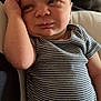 Elijah is registered to the contest to win money with this photo: baby, infant, striped_onesie, lying_down, arm, face, expression, dog, pet, sleeping, indoor, couch, pillow, skin, head, resting, cute, person, young_child, cozy
