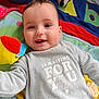 baby, child, clothing, colorful, cozy, cute, expression, face, happy, indoor, infant, lying_down, play_mat, playful, portrait, smiling, soft_toy, toy, warm, young_child