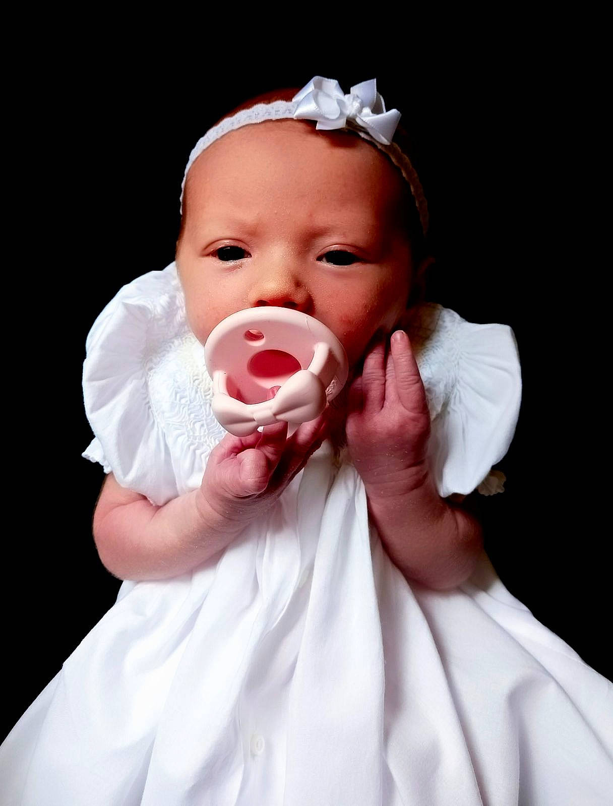 Victoria is registered to the contest to win money with this photo: baby, baby_toddler_clothing, cheek, dress, event, eyelash, finger, flash_photography, gesture, happy, headpiece, human_body, iris, lip, neck, person, petal, skin, sleeve, smile