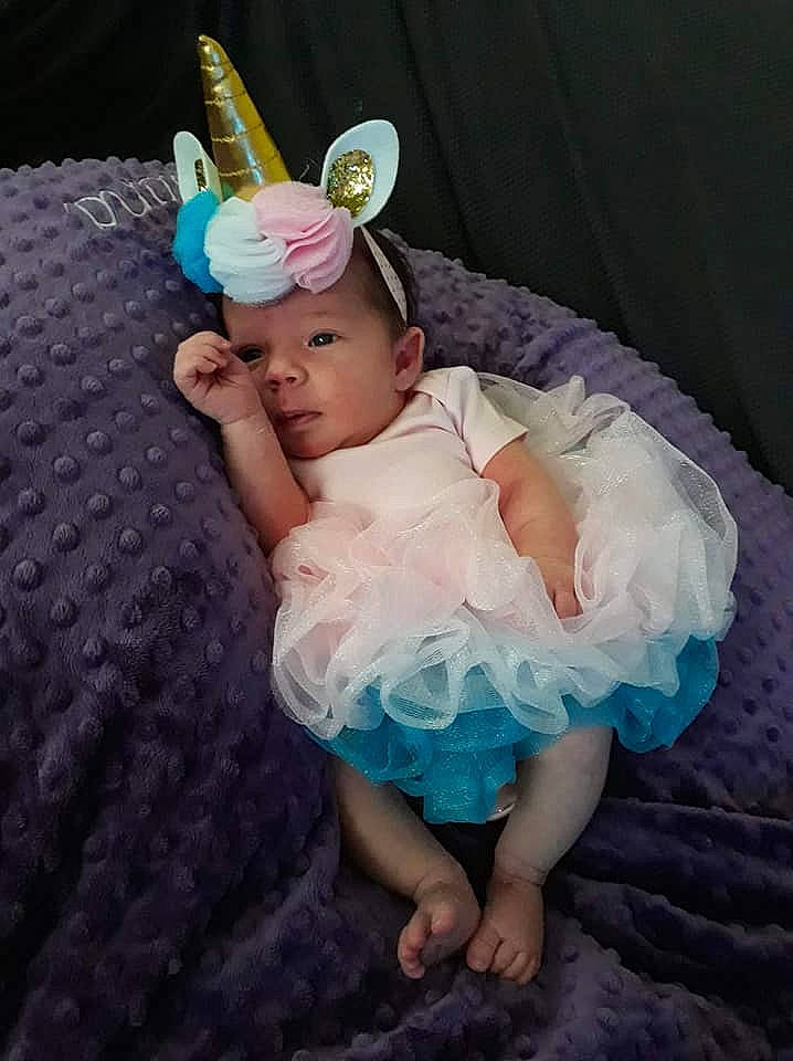 Briana is registered to the contest to win money with this photo: baby, baby_toddler_clothing, child, clothing, costume, costume_accessory, fashion_accessory, hair_accessory, headgear, headpiece, headwear, person, pink, toddler