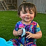 Sage is registered to the contest to win money with this photo: toddler, child, smiling, colorful_pajamas, wet_hair, grass, outdoor, toy, water_table, happy, playtime, person, face, hands, summer, daylight, fence, backyard, water_droplets, cute