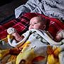 Elena joined the competition — help win amazing prizes! baby, blanket, bed, comforter, giraffe, plaid, striped, infant, child, laying, cozy, soft_lighting, indoor, warm, clothing, mitten, portrait, face, head, resting