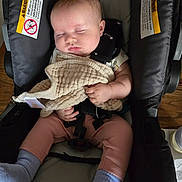 Elena joined the competition — help win amazing prizes! baby, sleeping, car_seat, blanket, clothing, socks, infant, child, peaceful, indoors, seatbelt, rest, cute, toddler, soft, comfort, nap, person, wood_floor, closeup