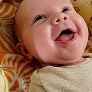 Elena is registered to the contest to win money with this photo: baby, smiling, infant, face, cute, blanket, pattern, honeybee, cushion, soft, happy, joyful, child, clothing, indoors, portrait, closeup, skin, head, lying