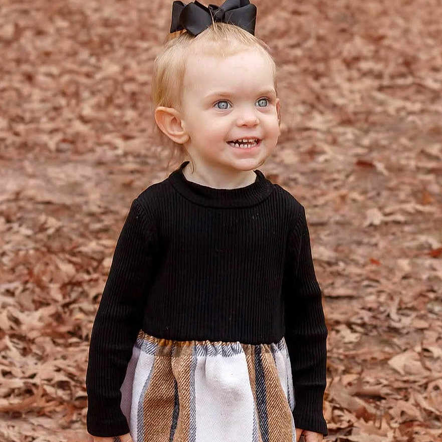 Ruby-Jean joined the competition — help win amazing prizes! autumn, black_bow, casual_clothing, child, cute, daytime, fall, fashion, happy, leaves, long_sleeve, nature, outdoor, person, plaid_skirt, portrait, smiling, standing, toddler, young_child