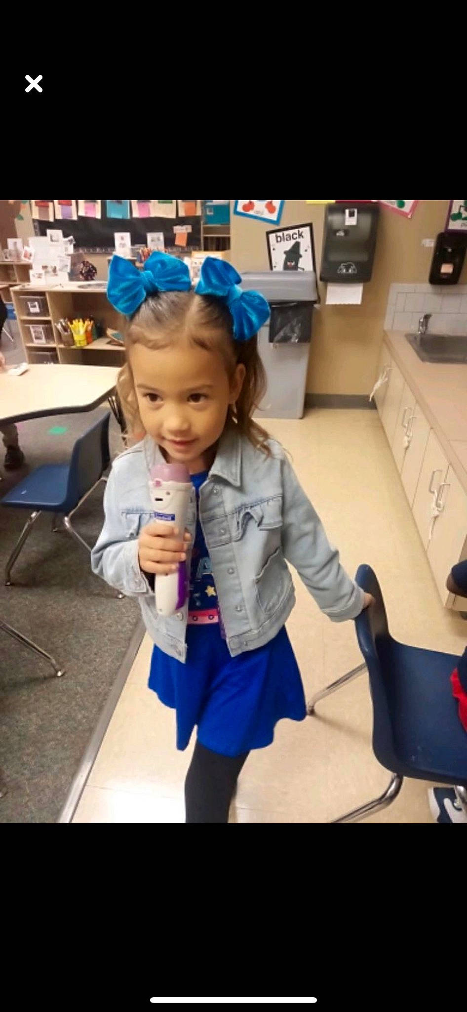 Ayleen is registered to the contest to win money with this photo: baby, chair, child, costume, electric_blue, event, flooring, fun, happy, home_appliance, human_leg, knee, person, room, school_uniform, sitting, skin, sleeve, standing, toddler