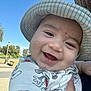 baby, child, smile, hat, striped_hat, mickey_mouse, shirt, outdoor, park, daylight, face, happy, cute, skin, hand, person, headwear, sunny, nature, closeup