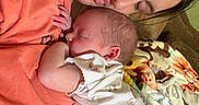Adaline joined the competition — help win amazing prizes! woman, baby, newborn, sleeping, holding, couch, blanket, indoor, love, family, mother, child, resting, comfort, clothing, face, skin, person, toddler, relaxation