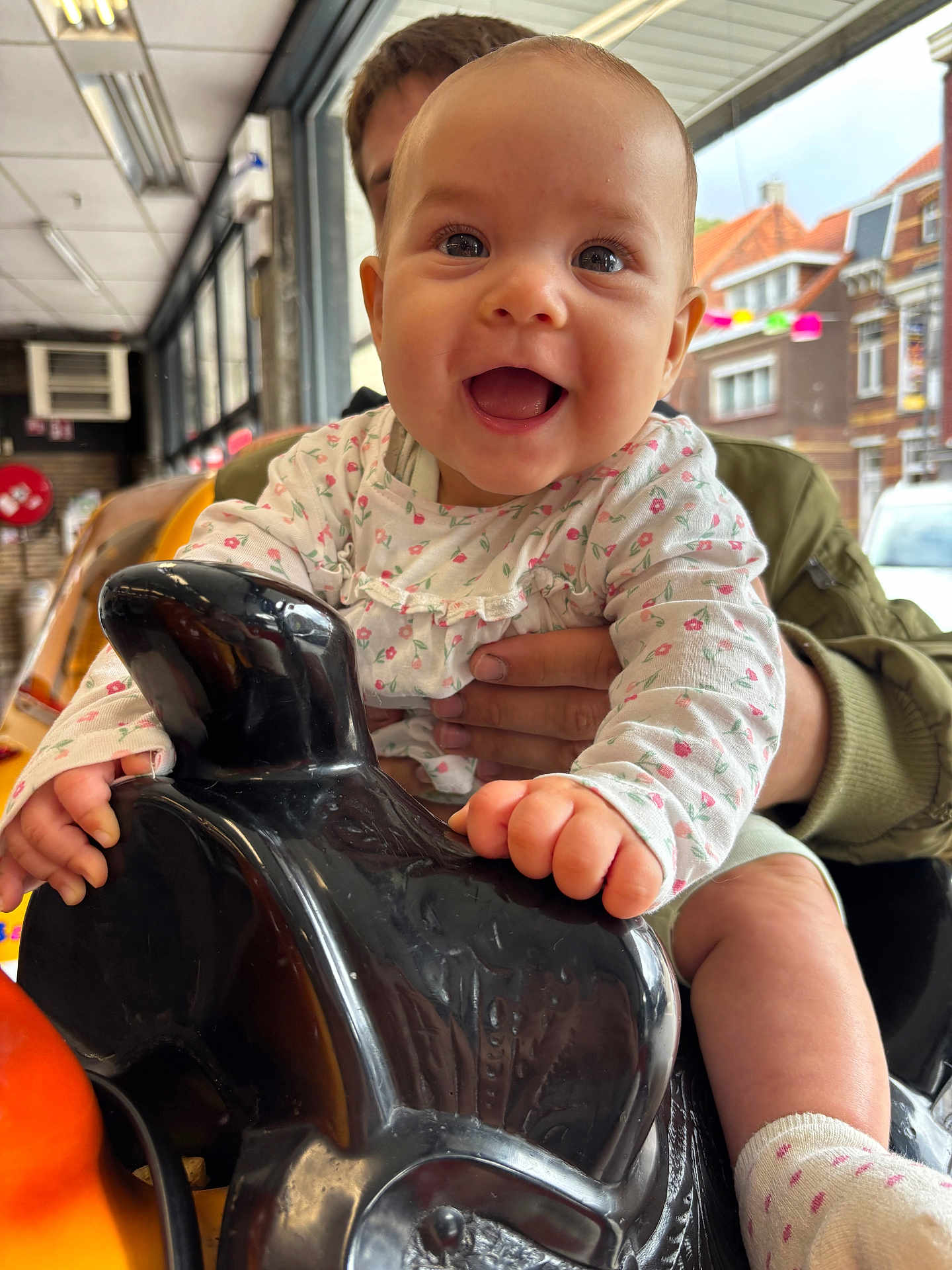Ailyna participe au concours pour gagner de l'argent avec cette photo : baby, child, smiling, indoor, rocking_horse, toy, hands, window, building, person, socks, face, clothing, happy, play, support, furniture, light, background, expression