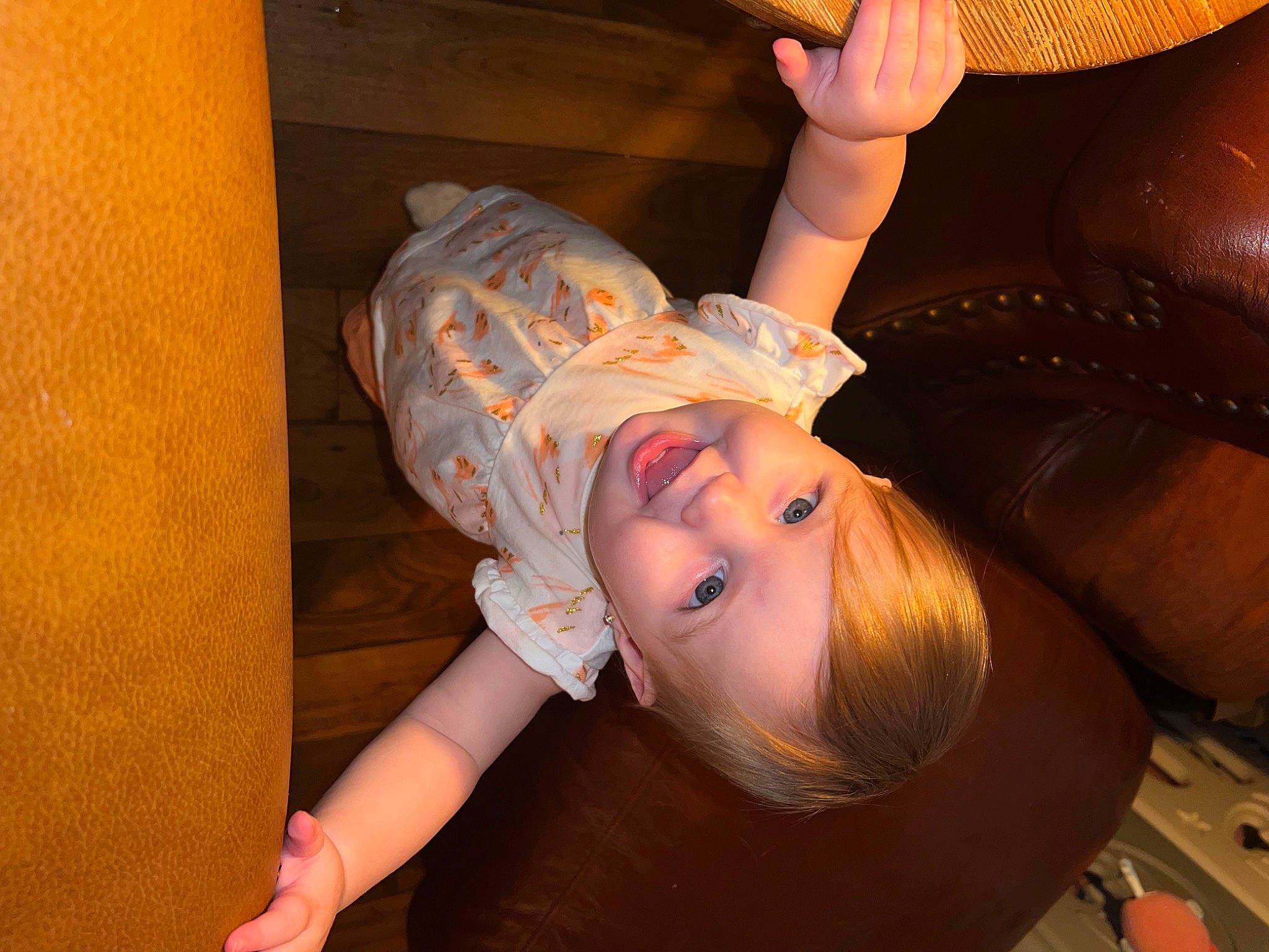 Cora is registered to the contest to win money with this photo: arm, baby_toddler_clothing, blond, cheek, comfort, eyelash, finger, flash_photography, flooring, fun, hand, happy, joy, mouth, nose, orange, person, skin, smile, thumb