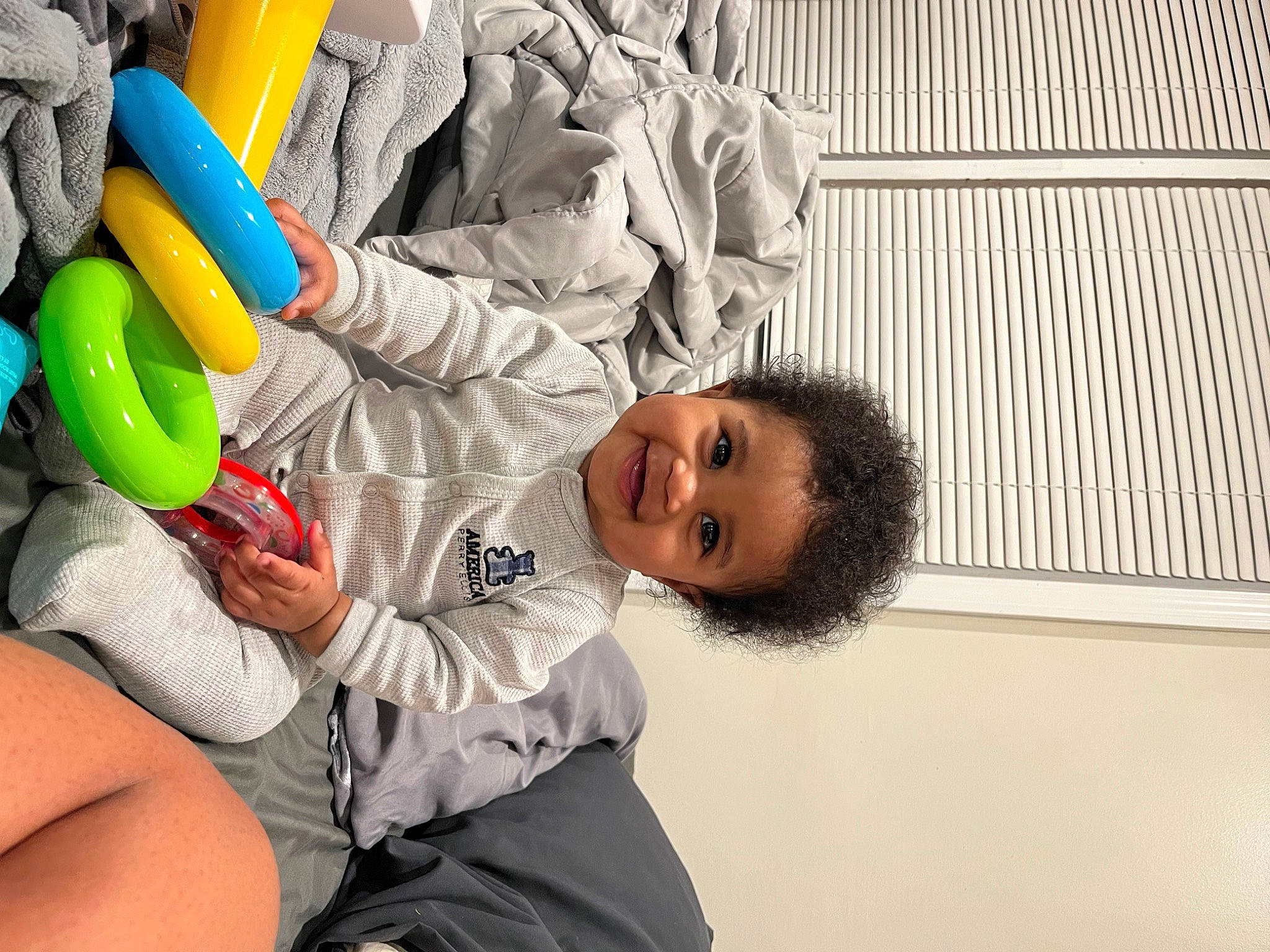 Magnus is registered to the contest to win money with this photo: baby, baby_products, balloon, child, comfort, fun, happy, joy, leisure, person, personal_protective_equipment, plastic, play, room, shorts, sitting, smile, t_shirt, toddler, toy