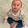 baby, child, sitting, sweater, clothing, jeans, barefoot, blanket, indoors, face, expression, cute, infant, person, portrait, young_child, holding, soft, comfort, curious