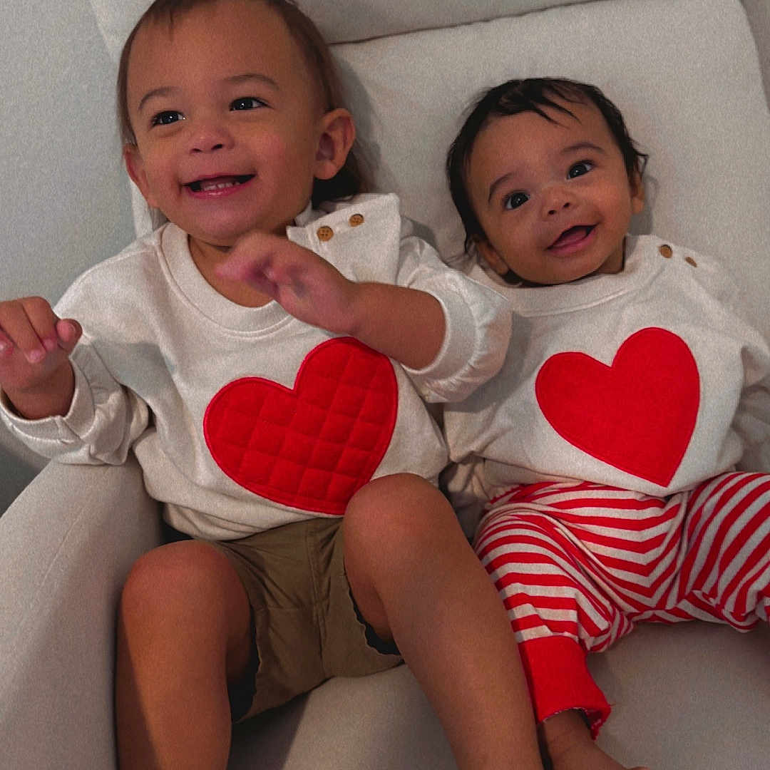 Emi And Santi joined the competition — help win amazing prizes! baby, bodypart, chair, clothing, couch, cushion, face, finger, furniture, hand, happy, head, heart, homedecor, person, photography, portrait, shorts, symbol, t_shirt