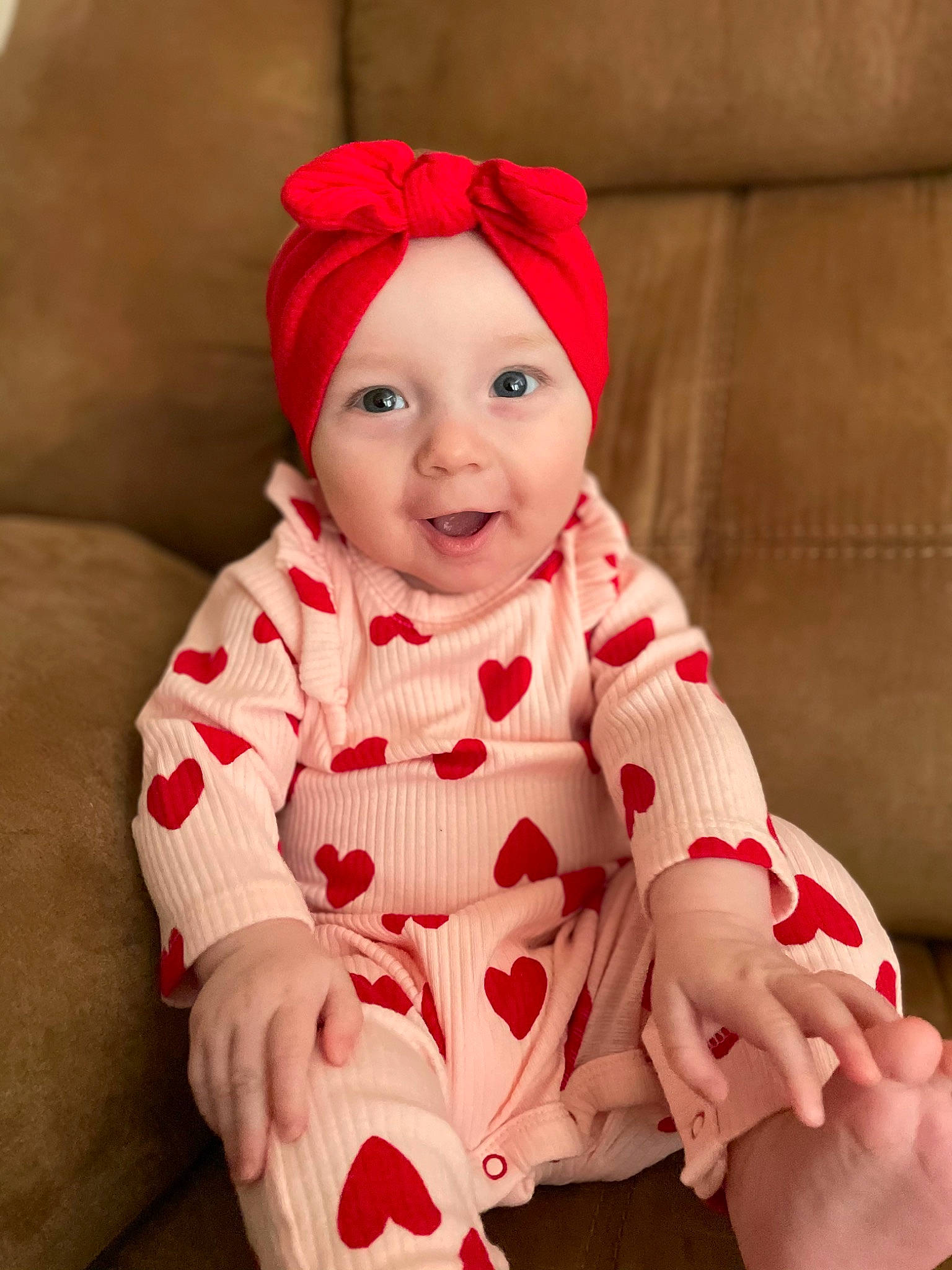 Lena is registered to the contest to win money with this photo: baby, baby_toddler_clothing, cap, child, comfort, costume_hat, eye, face, facial_expression, happy, head, headwear, human_body, lap, outerwear, person, pink, skin, sleeve, smile