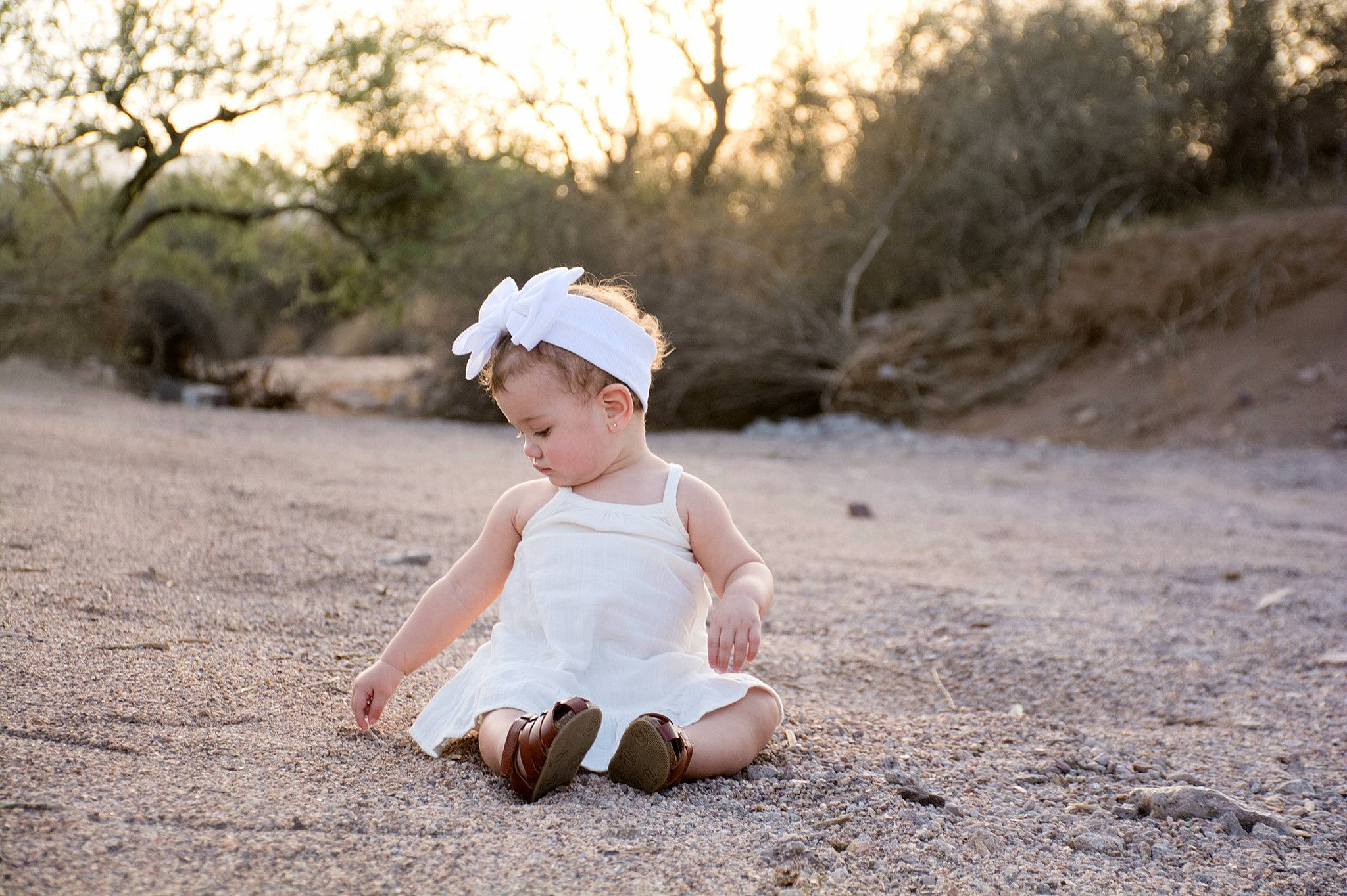 Kiyah is registered to the contest to win money with this photo: baby, baby_toddler_clothing, cap, child, dress, eyewear, fashion_accessory, flash_photography, fun, grass, happy, landscape, people_in_nature, person, plant, sand, sitting, sky, toddler, tree