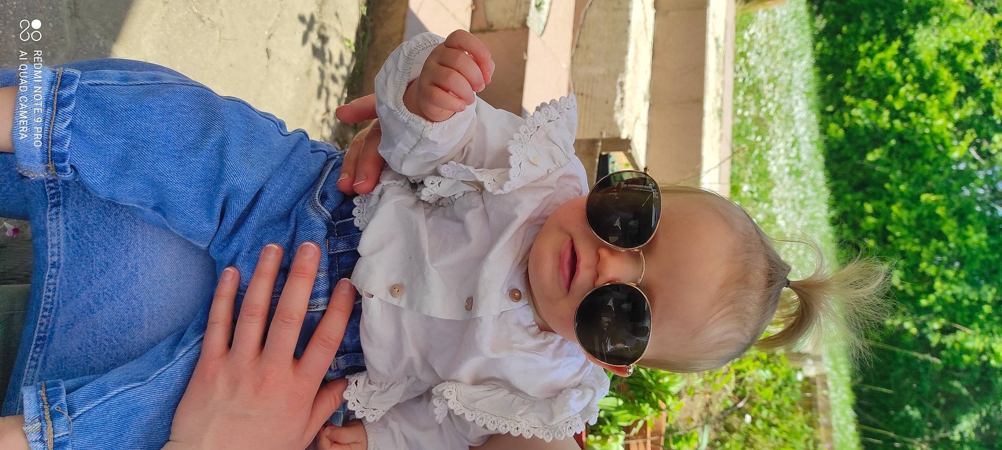 Léonie participe au concours pour gagner de l'argent avec cette photo : baby, baby_toddler_clothing, child, dress, event, eyewear, finger, gesture, goggles, green, hand, happy, hat, leisure, mouth, nail, person, plant, skin, sunglasses