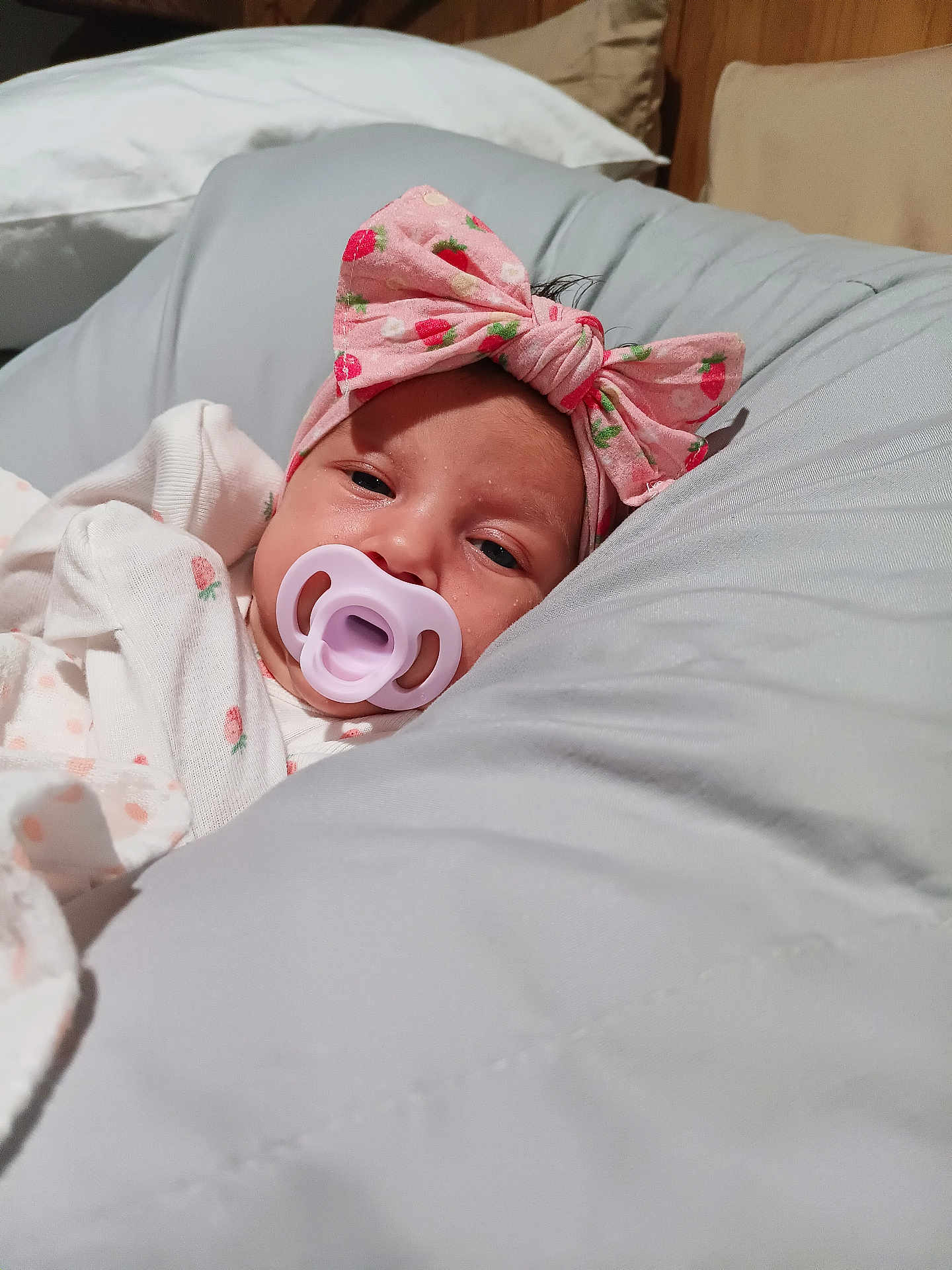 Jazmine Serenity is registered to the contest to win money with this photo: baby, pacifier, headband, pink_bow, blanket, pillow, sleepy, infant, closeup, face, comfort, resting, soft, indoors, cute, newborn, child, clothing, relaxation, portrait